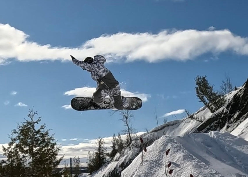 MHD rider Mathieu Morency doing a grab off a cliff