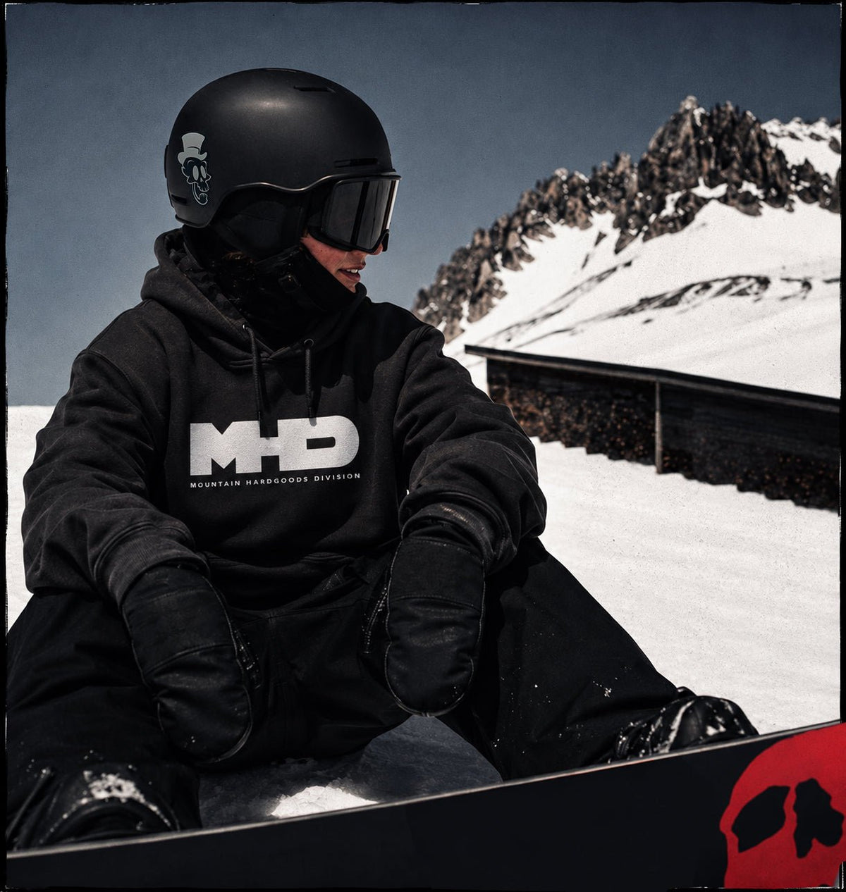 Rider wearing the Classic heavyweight snowboard hoodie by MHD with a black helmet and goggles