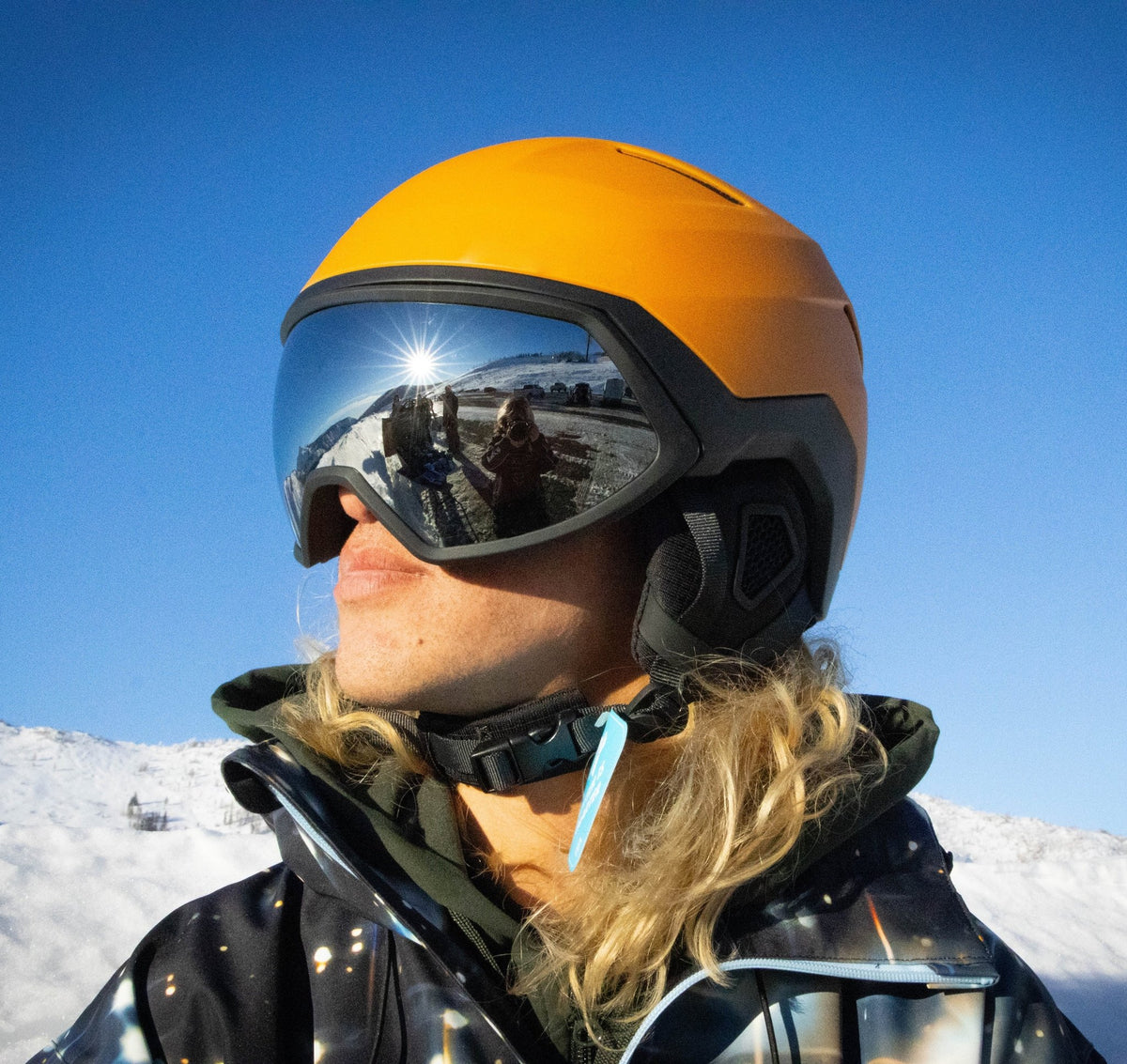 Skier wearing MHD EVOL yellow ski and snowboard helmet with Silver Mirror magnetic goggles