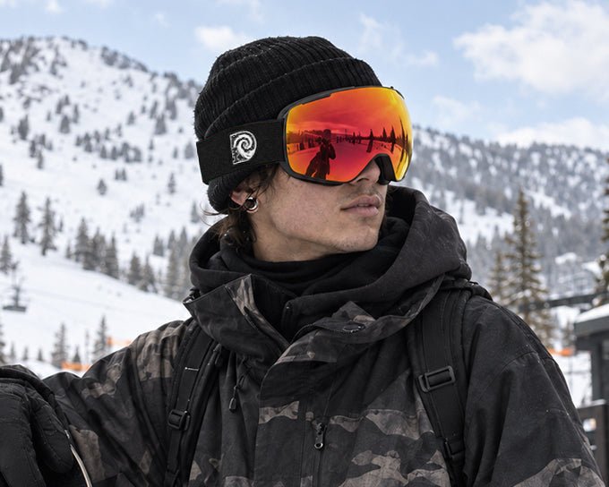 snowboarder wearing Hell Raiser ski snowboard goggles with photochromic spherical lens by MHD