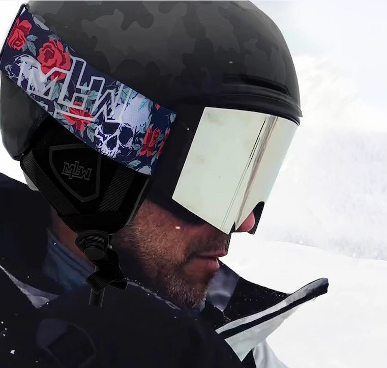 Snowboarder wearing Shredder snowboarding helmet and Skull and Roses snow goggles by MHD on snow